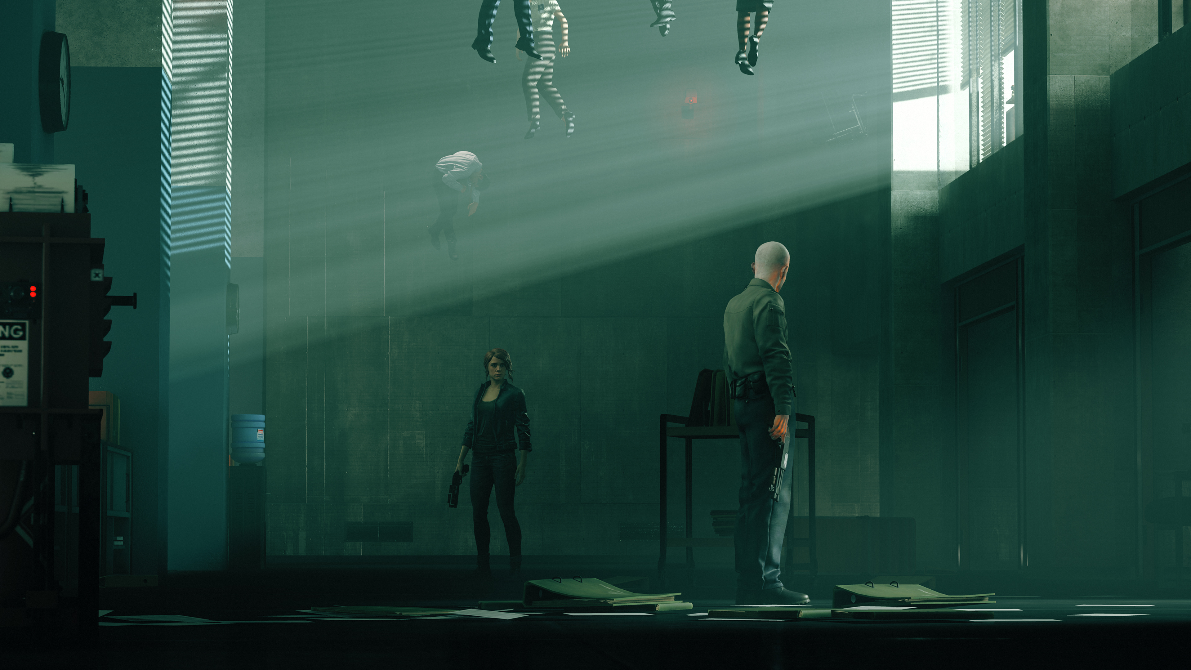 Jesse Faden from Control standing tensely infront of a bald man. The photo is very green hued and there are bodied floating near the roof.