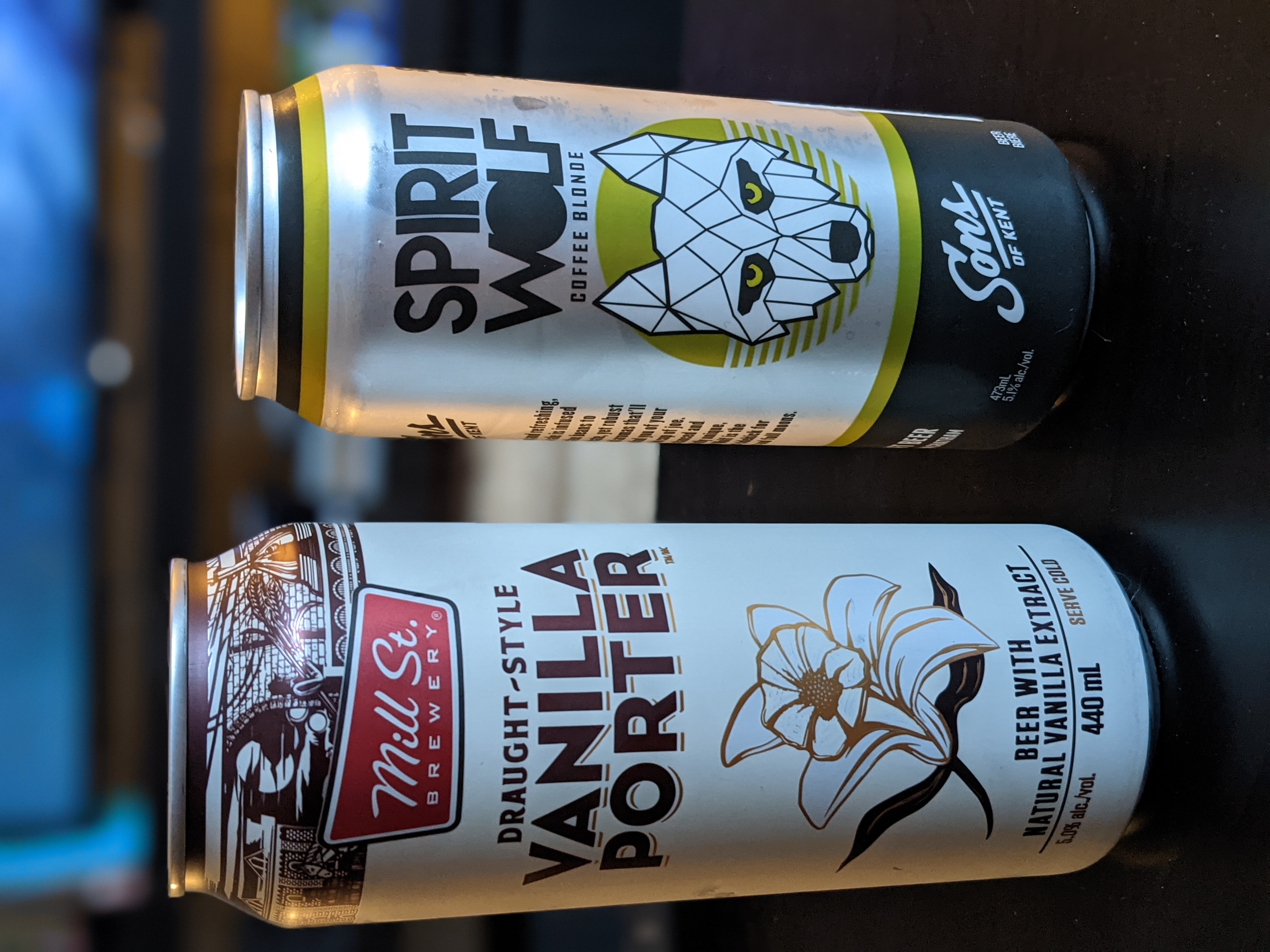 Two beers on a coffee table, the left one is a vanilla porter from Mill Street Brewery, the other is Spirit Wolf brand Coffee Blond.