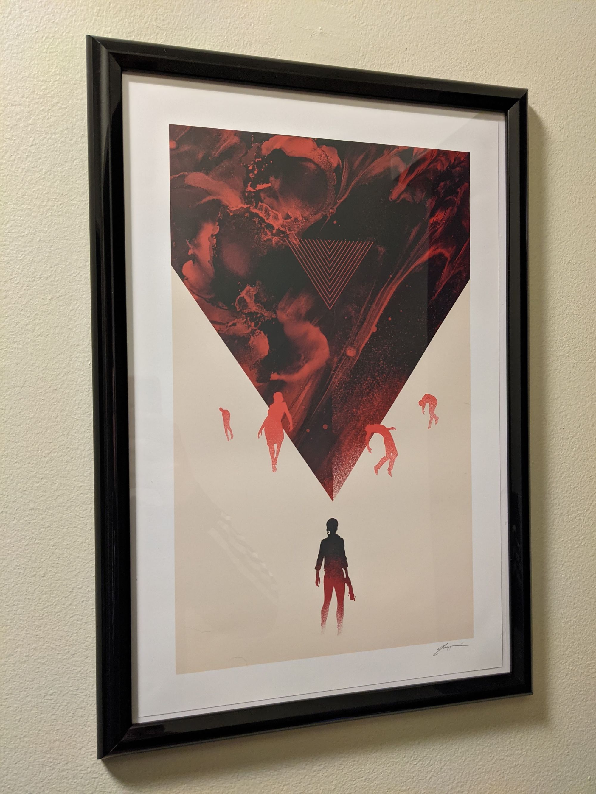 A Control print inside a simple black frame. There is a silhouette of the protagonist underneath an upside down red triangle. There are silhouettes of floating bodies around the triangle above.